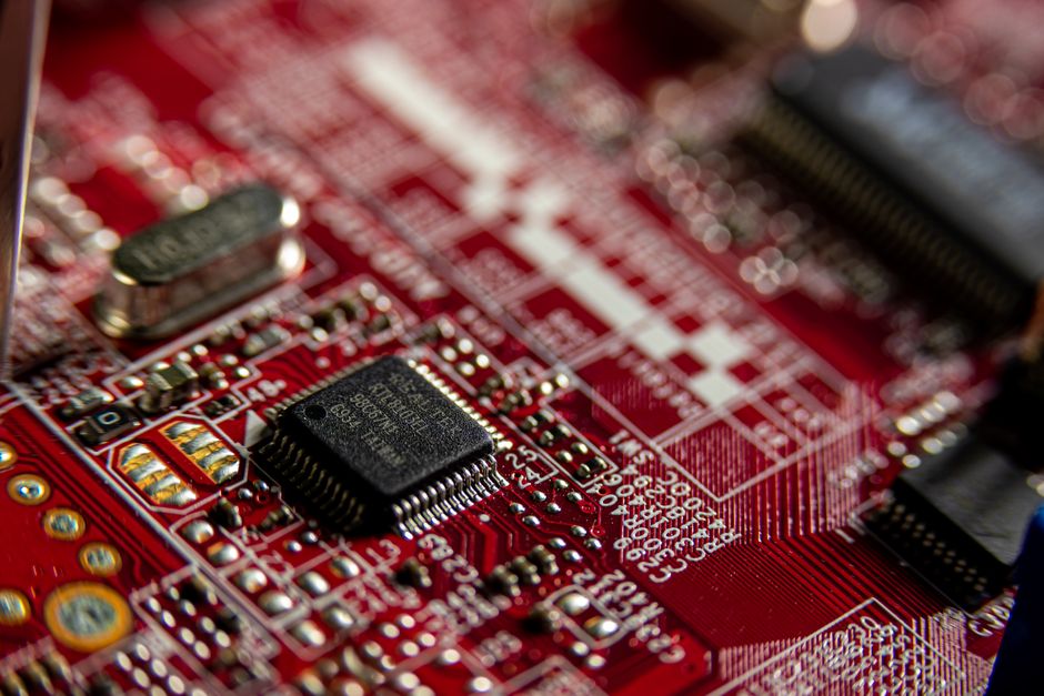 macro shot of a microchip circuit board with glowing lines, editorial tech style